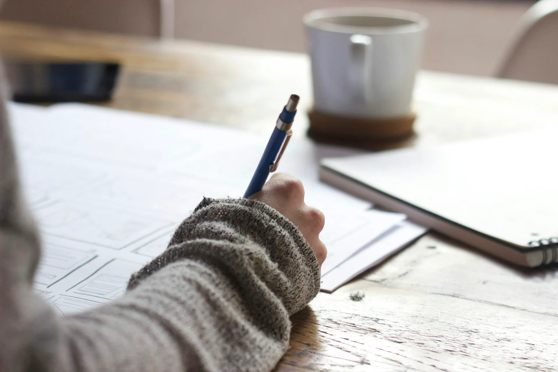 Student studying for real estate exam with books and notes